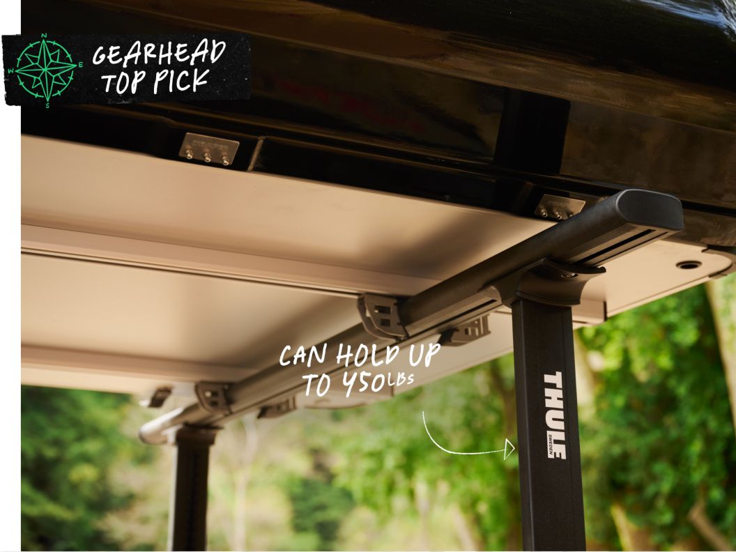 A rack in the back of a truck holds up a rooftop tent. Text overlay reads: Gearhead top pick, thule xsporter pro aluminum rack. 